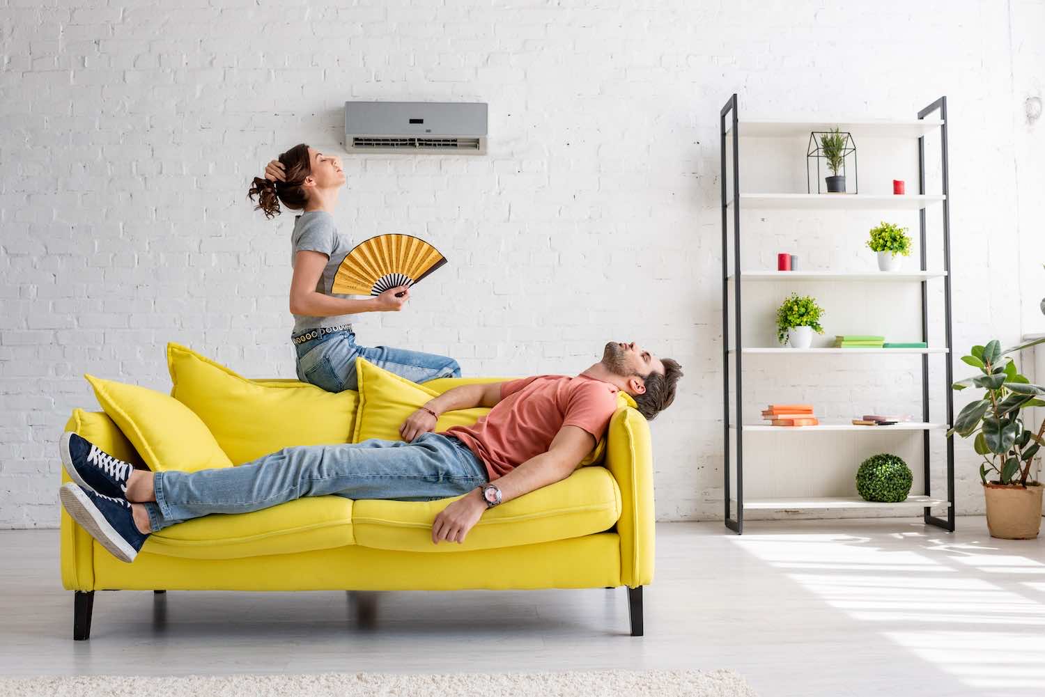 a couple sitting on a couch on a hot day