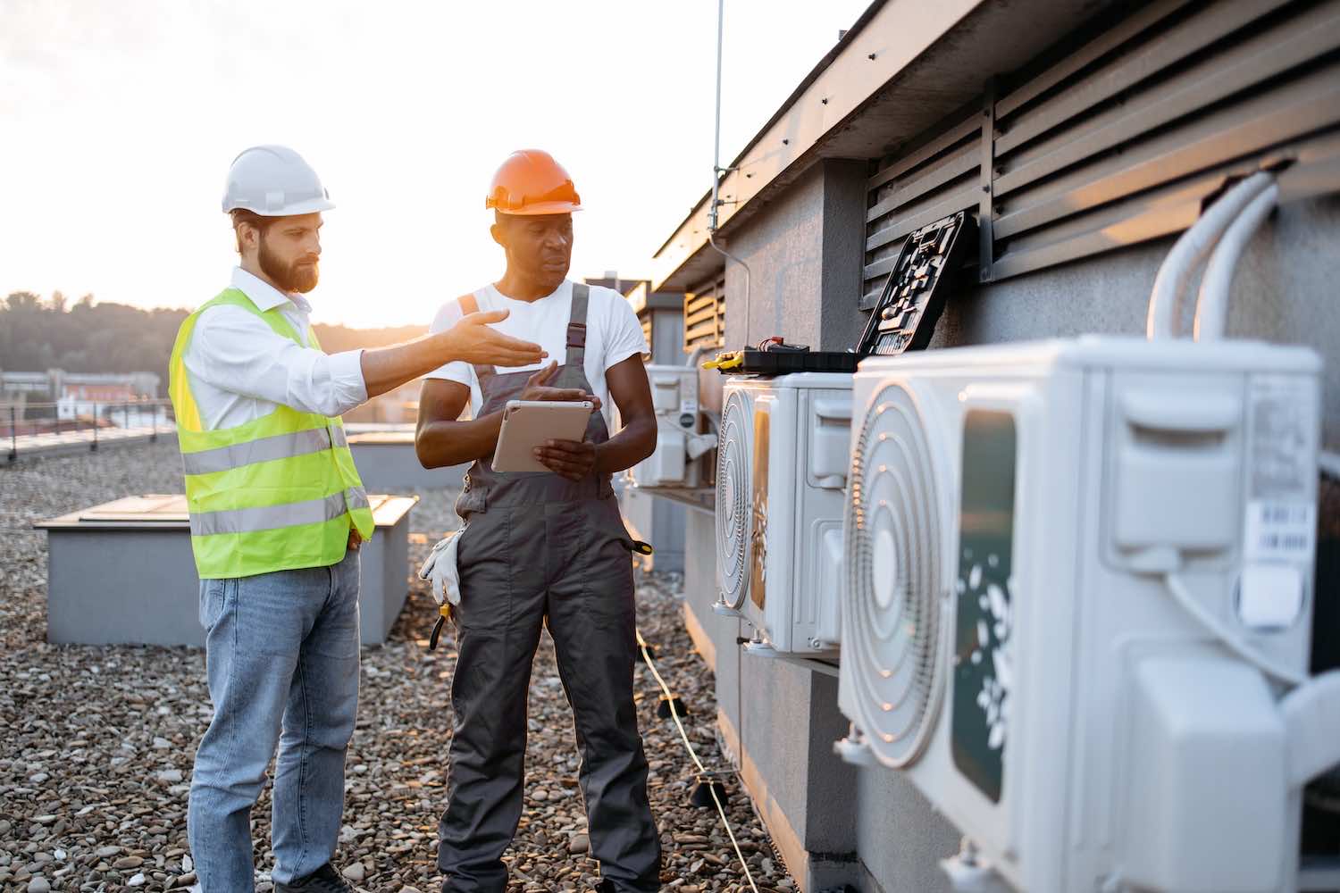 two technicians reviewing the cost of a commercial hvac repair