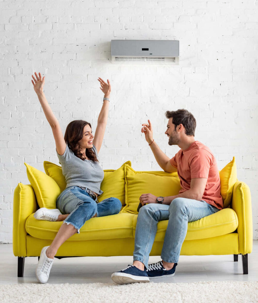 couple enjoy their air conditioning on the couch