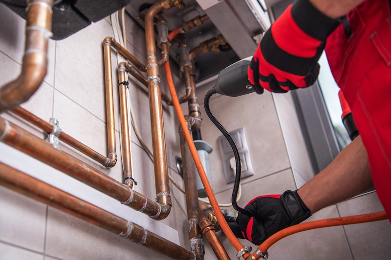 technician checking a gas line leak